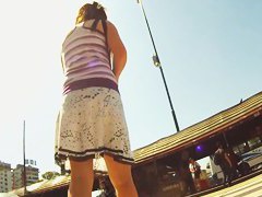 A couple of ladies are in an upskirt porno where their asses are shown
