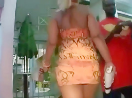 Ass in short orange dress