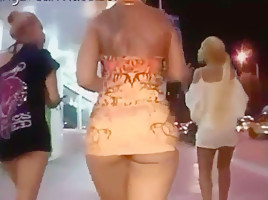 Ass in short orange dress