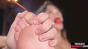 Ballgagged BDSM babe tormented in painful feet lesson