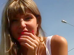 Blonde plays beside motorway
