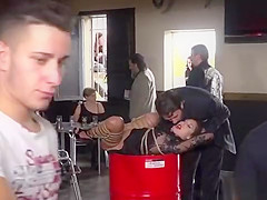 Bound brunette humiliated in bikers shop