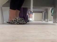 Female feet and shoes in the public toilet