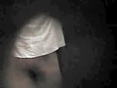 Girl in back bra seems to have noticed a hole in the wall