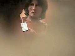 Girl in back bra seems to have noticed a hole in the wall