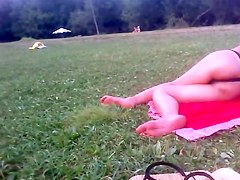 Girl in tiniest bikini getting sun tanned in the field PICT0011