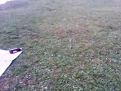Girl in tiniest bikini getting sun tanned in the field PICT0011
