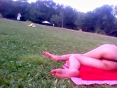 Girl in tiniest bikini getting sun tanned in the field PICT0011