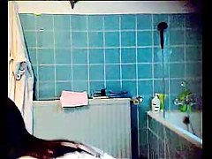Slender brunette with small tits on the shower