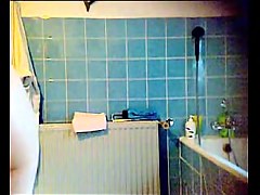 Slender brunette with small tits on the shower