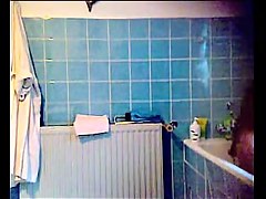 Slender brunette with small tits on the shower
