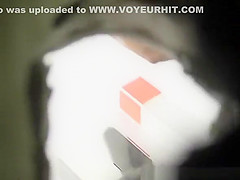 Tanned ass woman spied in public toilet peeing