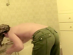 Teenage girl bent over a bath tub