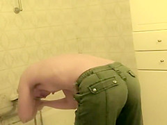 Teenage girl bent over a bath tub