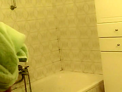 Teenage girl bent over a bath tub