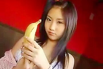Titless Asian teen 18+ plays with a banana