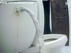 Woman takes a piss in toilet