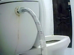Woman takes a piss in toilet
