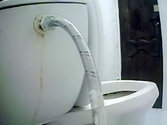 Woman takes a piss in toilet