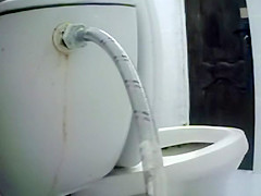 Woman takes a piss in toilet