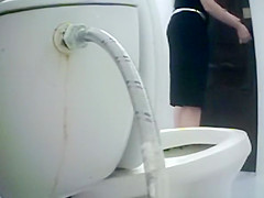 Woman takes a piss in toilet
