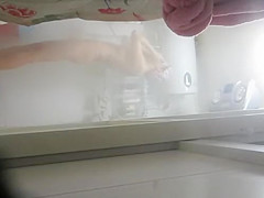 Woman undressing to wash her tight body