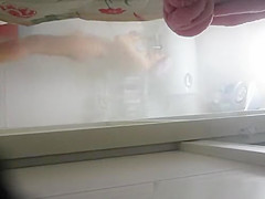 Woman undressing to wash her tight body