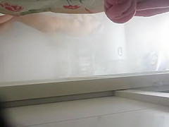 Woman undressing to wash her tight body
