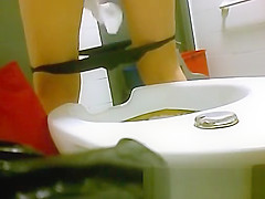 view from behind of women pissing in the toilet