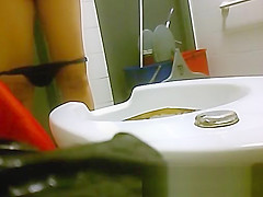 view from behind of women pissing in the toilet
